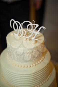 Three-tiered white-and-beige cake for the wedding.