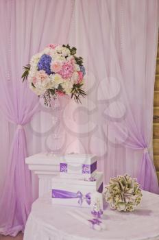 The festive elements of decoration of the room with bunches of flowers.