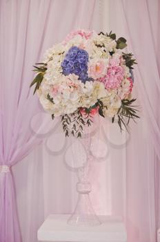 The festive elements of decoration of the room with bunches of flowers.