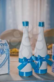 Beautiful bottles decorated with ribbons for wedding.