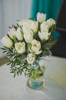 A bouquet of white roses as an element of decoration of the festive table.