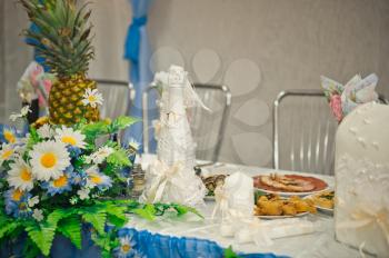 A table decorated with a pineapple and flowers.