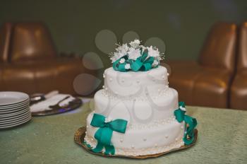 Wedding cake decorated with ribbons and flowers.
