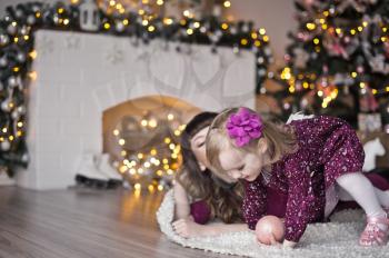 A child sitting around the Christmas tree.