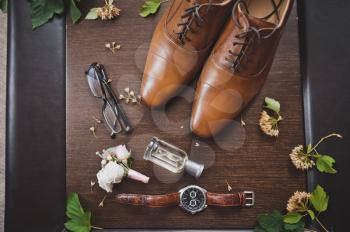 Men glasses watches and perfume with a boots.