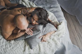 A man and a girl bask in the morning in bed.