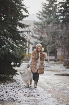 A girl walks on a leash your dog.