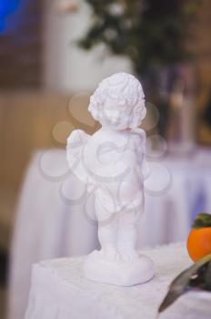 Figurine angel with a heart in his hands.