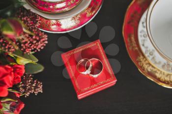 Artsy wedding rings on the red box.
