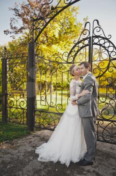 The couple stand about elegant wrought-iron gates of the estate.