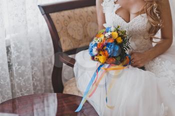 The bride holds a bouquet of flowers.