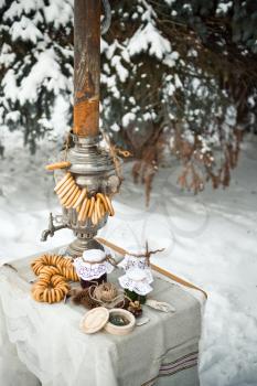 Tea with bagels from a samovar in nature in the winter.