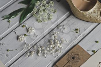 Womens jewelry on a white wooden table.