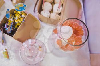 Sweets and candies on the table in glasses.