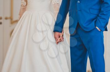 The couple hold hands tightly at the marriage ceremony.