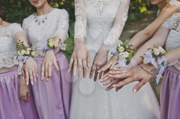 Womens hands with the same floral decorations.