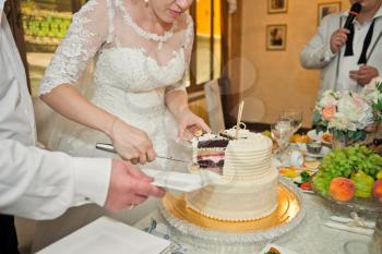 The process of cutting the cake the newlyweds apart.
