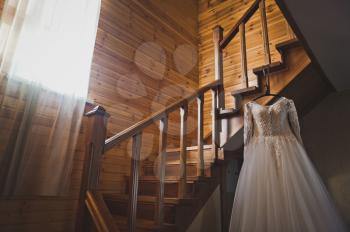 The brides dress lies on the staircase leading to the second floor.