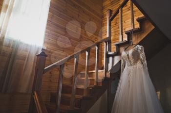 The brides dress lies on the staircase leading to the second floor.
