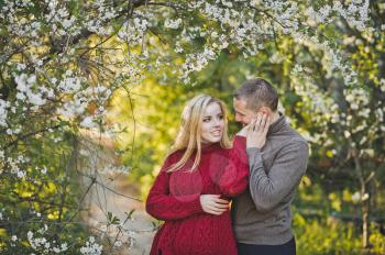 Couple in love on the background of flowering trees.