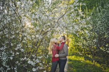 A happy couple against the background of the blossoming nature.