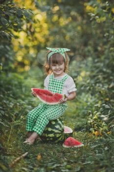 A happy child eats a juicy slice of watermelon.