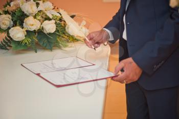 The process of signing an important document with a pen.
