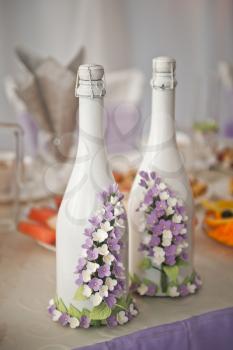 Traditional decorated with the bride bottle of champagne.
