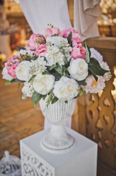 Vases with bouquets of flowers as elements of decoration of the festive hall.
