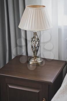 Lamp on the bedside table in a chic performance.