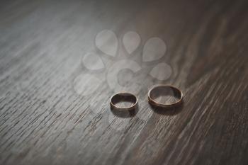 Two rings of different sizes on a beautiful table.