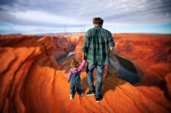 dad with daughter. Famous Horseshoe Bend of the Colorado River in northern Arizona
