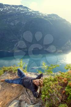 man in the mountains overlooking the fjord. top view