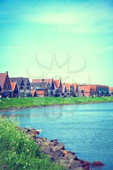 ishing village of Volendam in Holland in the summer by the sea. Made in the style of retro vintage instagram