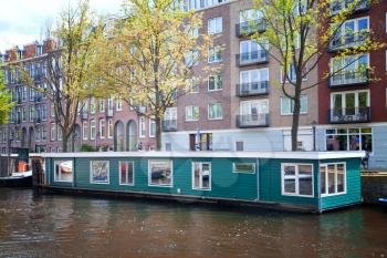 sunny summer day in Amsterdam. floating houses on the canals and bridges