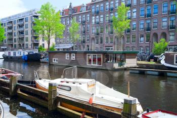 sunny summer day in Amsterdam. floating houses on the canals and bridges