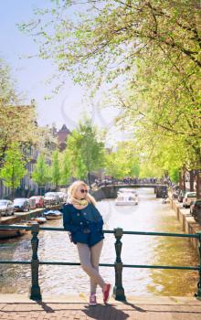 beautiful young blonde woman walking on a sunny day in Amsterdam