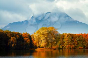 Golden Autumn at the lake on a background of mountains.