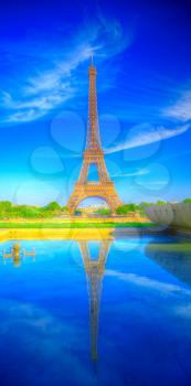 Eiffel Tower reflected in water. HDR photography. Summer in Paris