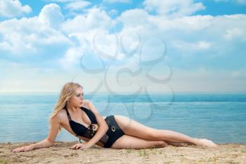 girl lying on the beach, sunbathing and relaxing. Summer journey to the sea.