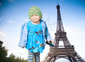 little girl on the background of the Eiffel Tower. small French two years on a sunny day walking around Paris