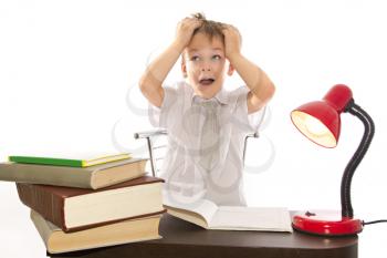 child sitting at his desk, preparing lessons