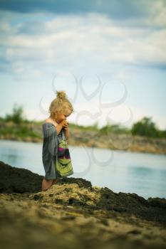 portrait of a little girl on the beach in the summer .