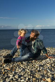 Daughter and dad relax on the beach. family holiday
