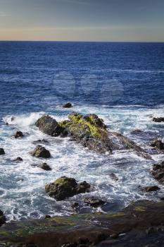 Rocks in sea near Puerto de la Cruz town on coast of Tenerife island, Spain