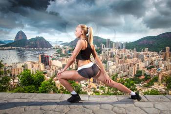 Girl is engaged in gymnastics in Rio against the backdrop of the city and mountains