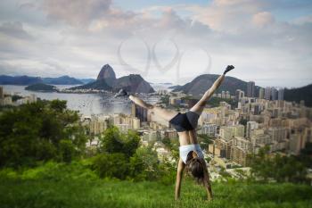 Girl is engaged in gymnastics in Rio against the backdrop of the city and mountains