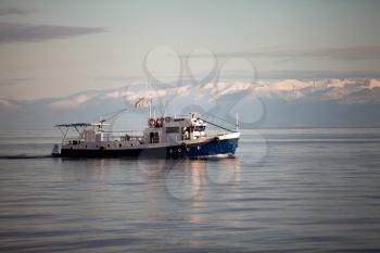 ship at the Baikal lake in siberia, Russia, mountains background