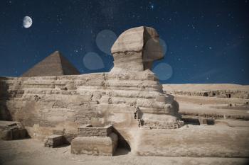 Guardian Sphinx guarding the tombs of the pharaohs in Giza. Cairo, Egypt. night shining moon and stars.