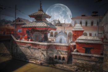 moon. Votive temples and shrines in a row at Pashupatinath Temple, Kathmandu, Nepal.